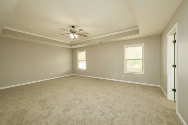 a bathroom with a granite countertop sink a toilet a mirror and shower