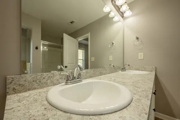 an empty room with fan and windows