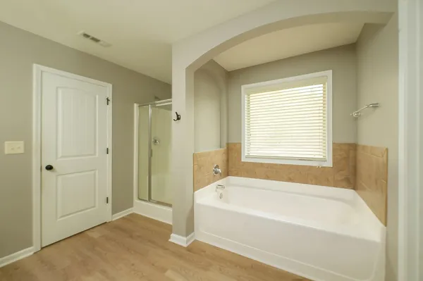 a bathroom with a granite countertop sink vanity and mirror