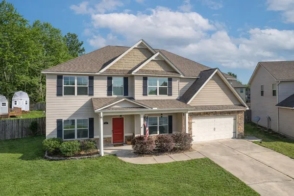 a view of staircase with lots of frames on wall and a large window
