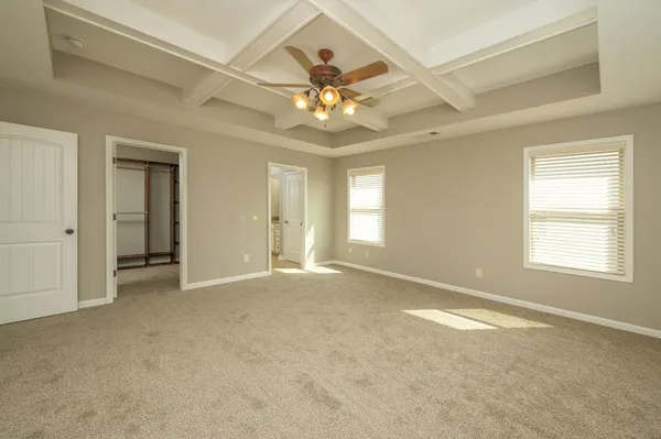 a view of a dining room with furniture a rug and wooden floor