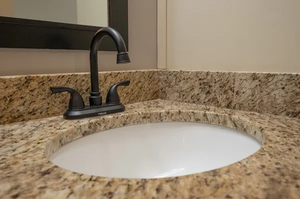 a view of backyard with swimming pool and seating space