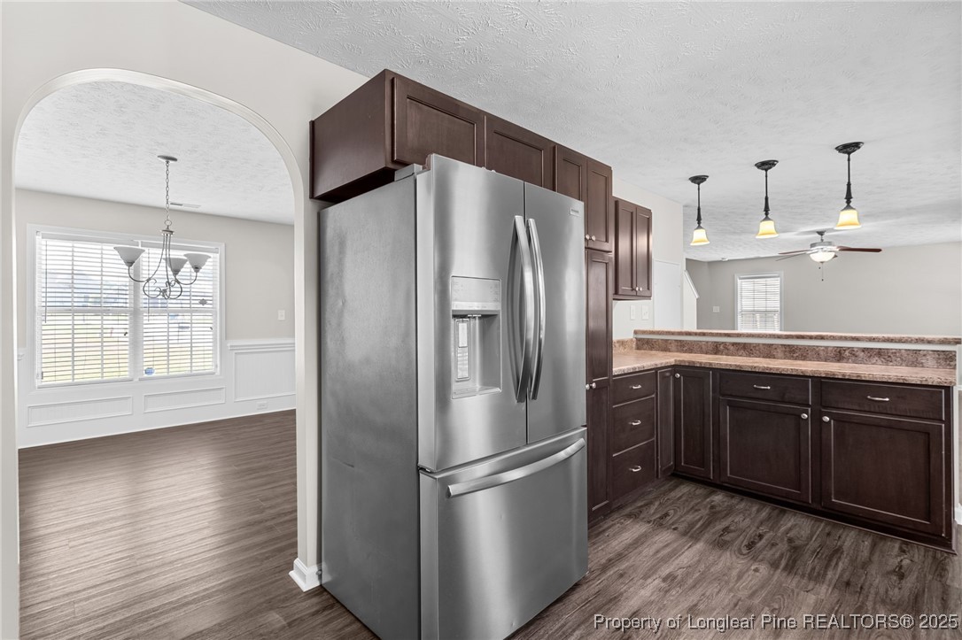 186 Scanner Court Raeford, NC 28376 - Photo 11 of 49 a kitchen with stainless steel appliances granite countertop a refrigerator a sink and wooden cabinets
