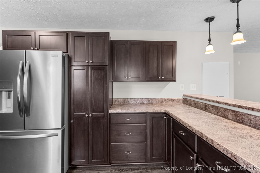 186 Scanner Court Raeford, NC 28376 - Photo 13 of 49 a kitchen with a refrigerator a sink and cabinets