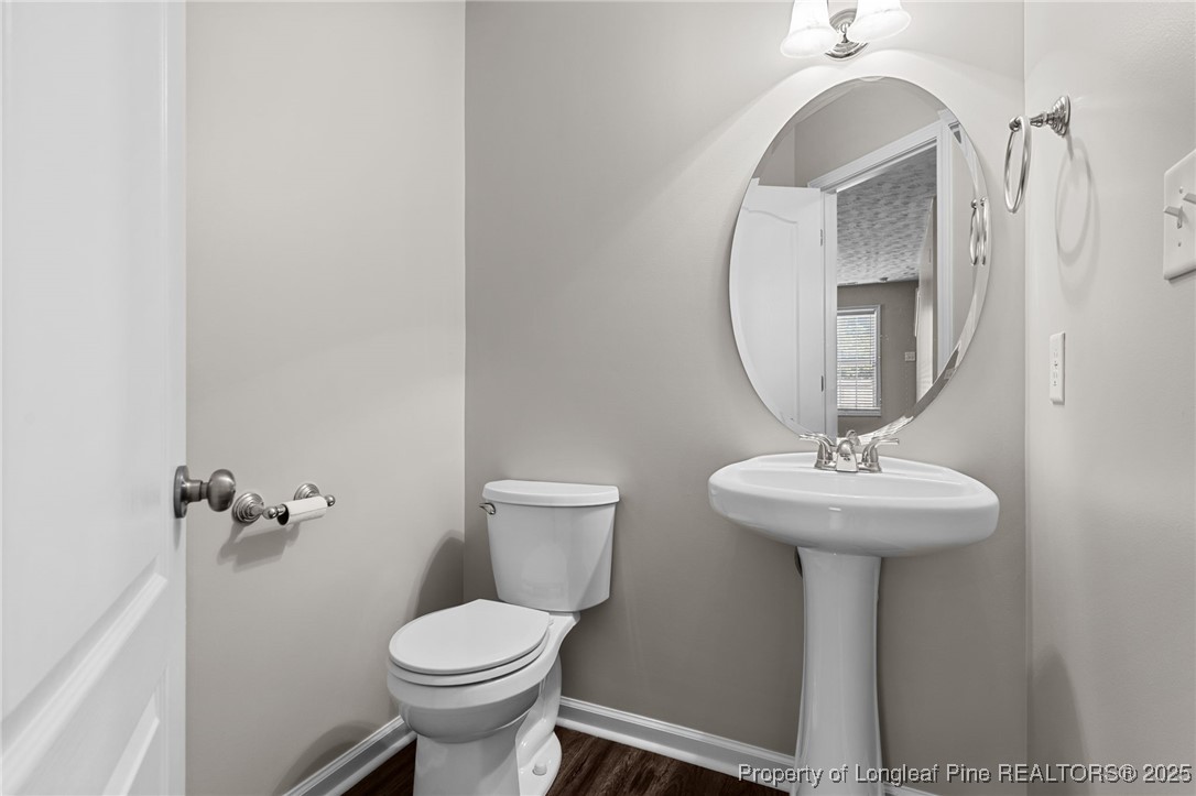 186 Scanner Court Raeford, NC 28376 - Photo 20 of 49 a bathroom with a toilet sink and mirror