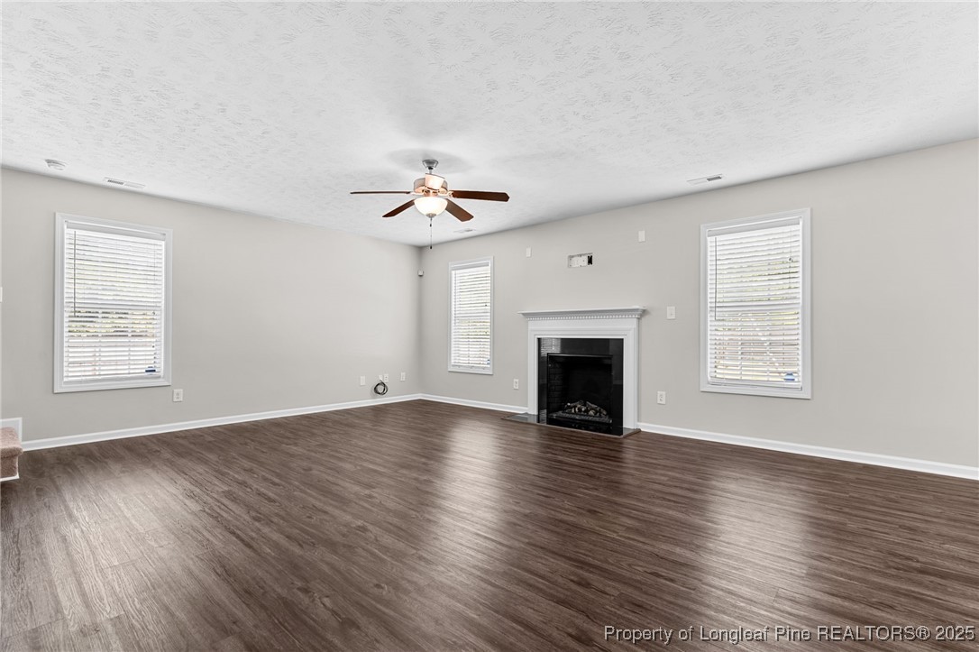 186 Scanner Court Raeford, NC 28376 - Photo 21 of 49 a view of an empty room with wooden floor and a window