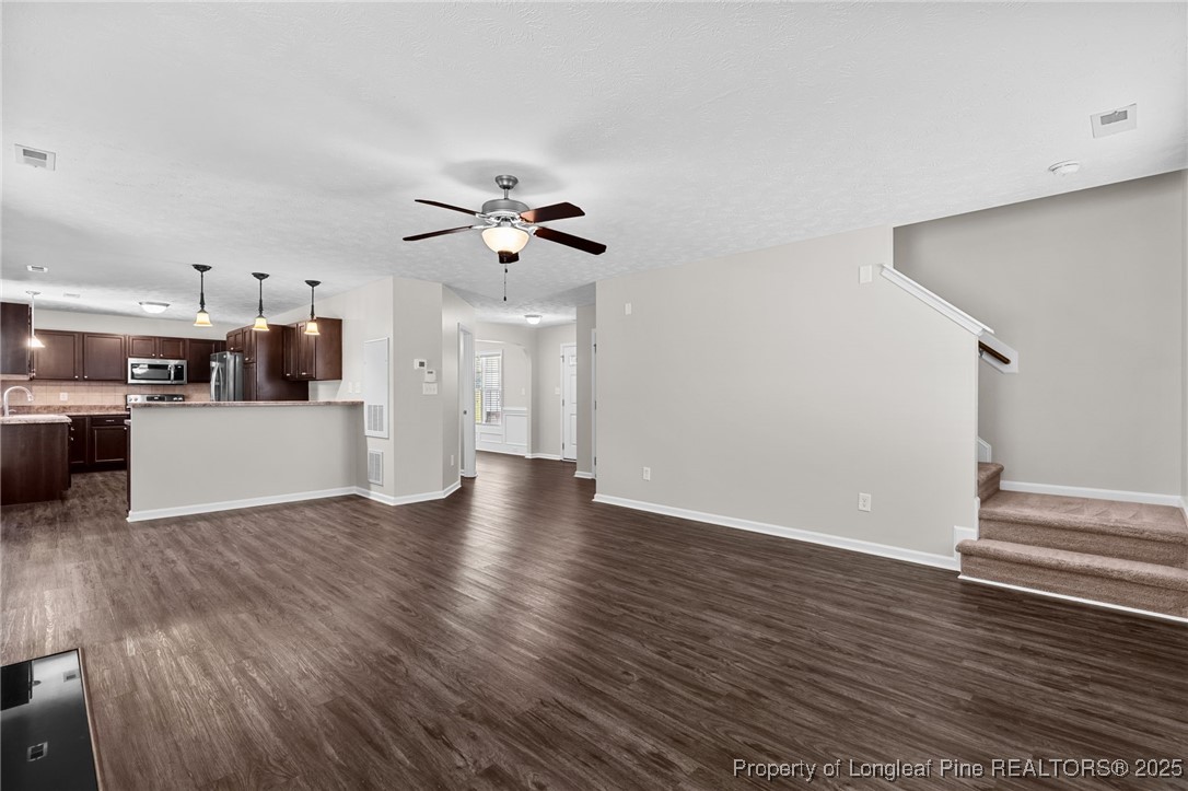 186 Scanner Court Raeford, NC 28376 - Photo 23 of 49 a view of a kitchen with wooden floor and a ceiling fan