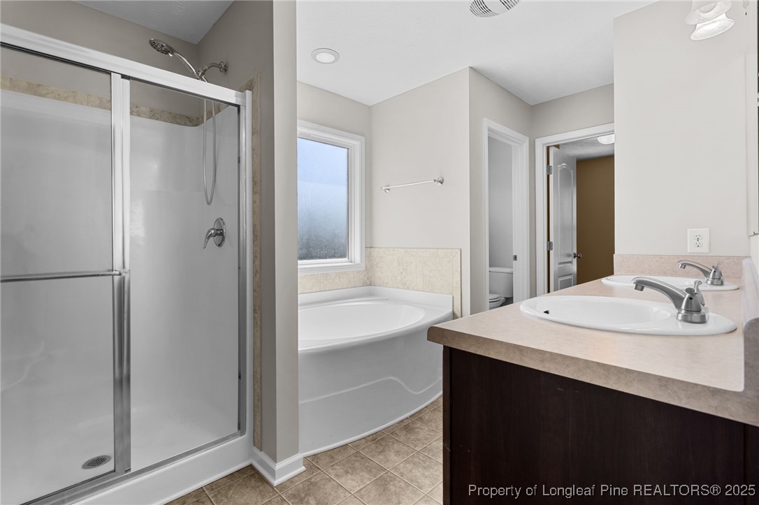 186 Scanner Court Raeford, NC 28376 - Photo 31 of 49 a bathroom with a sink and a mirror