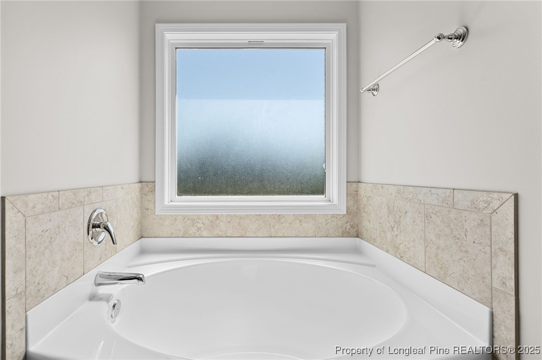 186 Scanner Court Raeford, NC 28376 - Photo 32 of 49 a white bath tub sitting next to a window