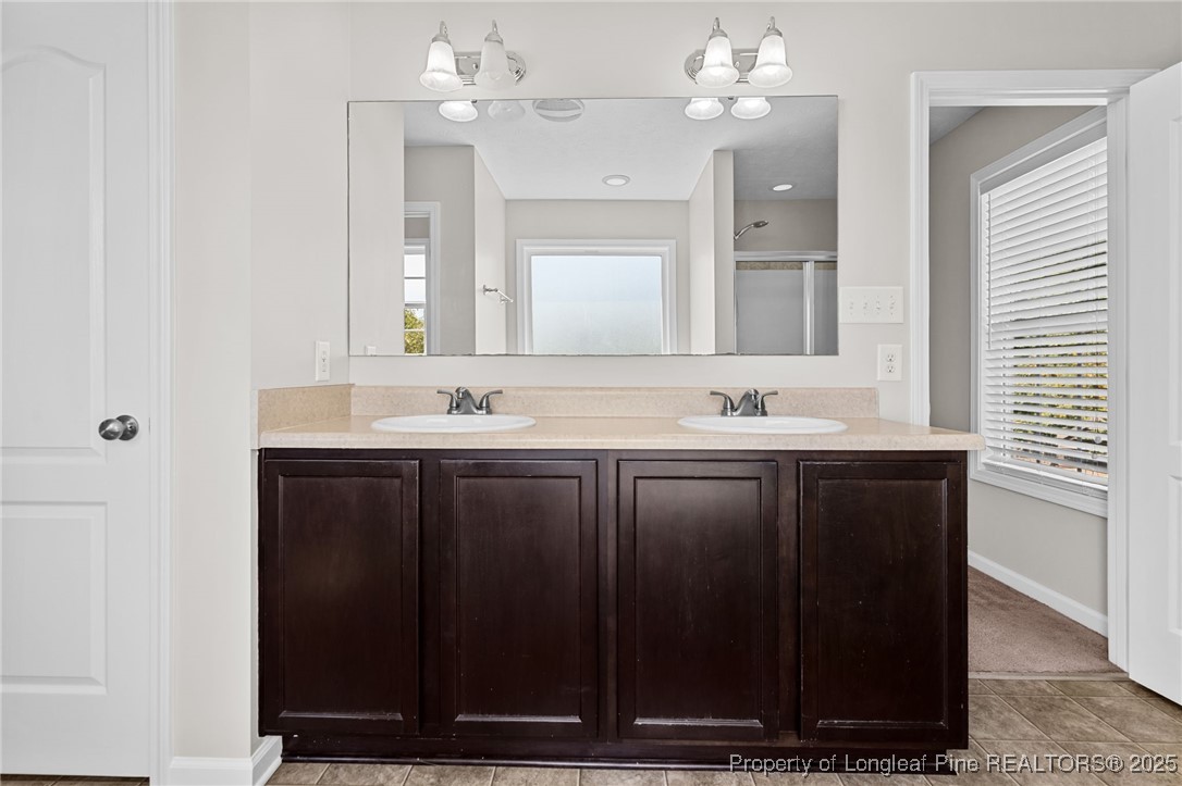 186 Scanner Court Raeford, NC 28376 - Photo 33 of 49 a bathroom with a sink vanity granite and a mirror