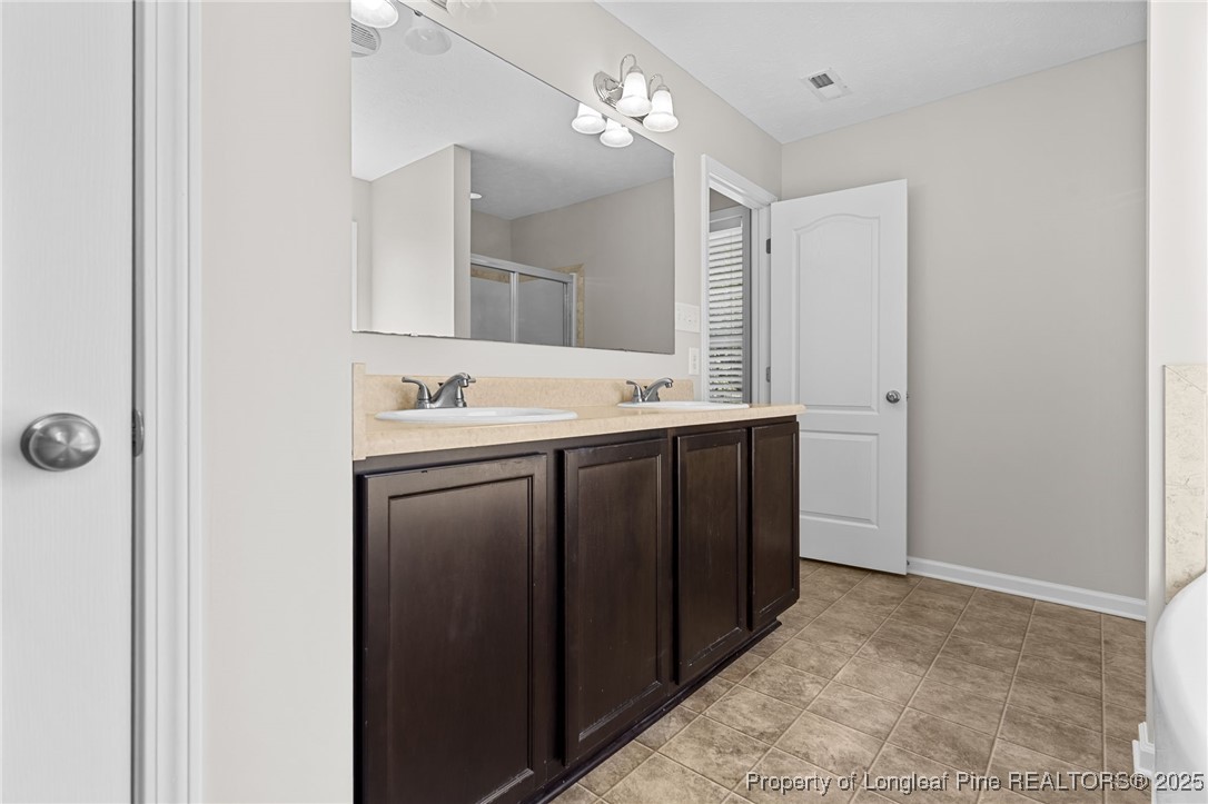 186 Scanner Court Raeford, NC 28376 - Photo 34 of 49 a bathroom with a sink and a mirror