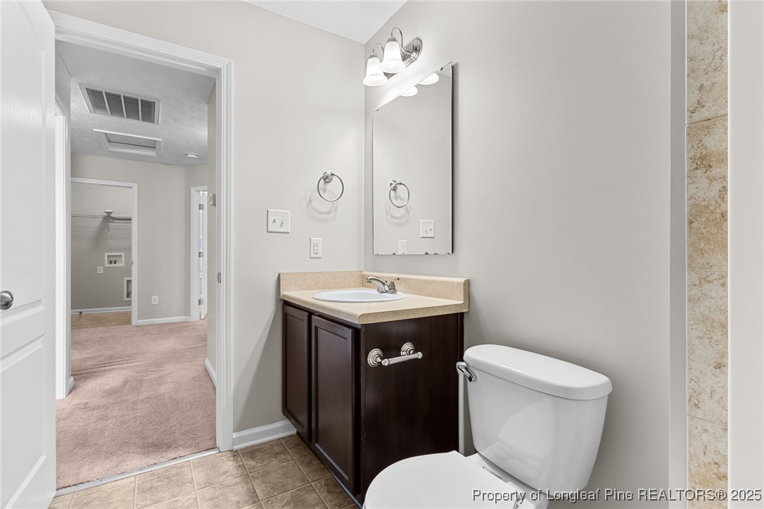 186 Scanner Court Raeford, NC 28376 - Photo 40 of 49 a bathroom with a sink toilet and shower