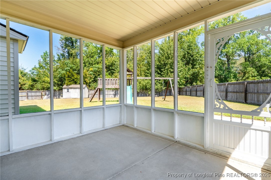 186 Scanner Court Raeford, NC 28376 - Photo 42 of 49 a view of an empty room with a floor to ceiling window and an outdoor view