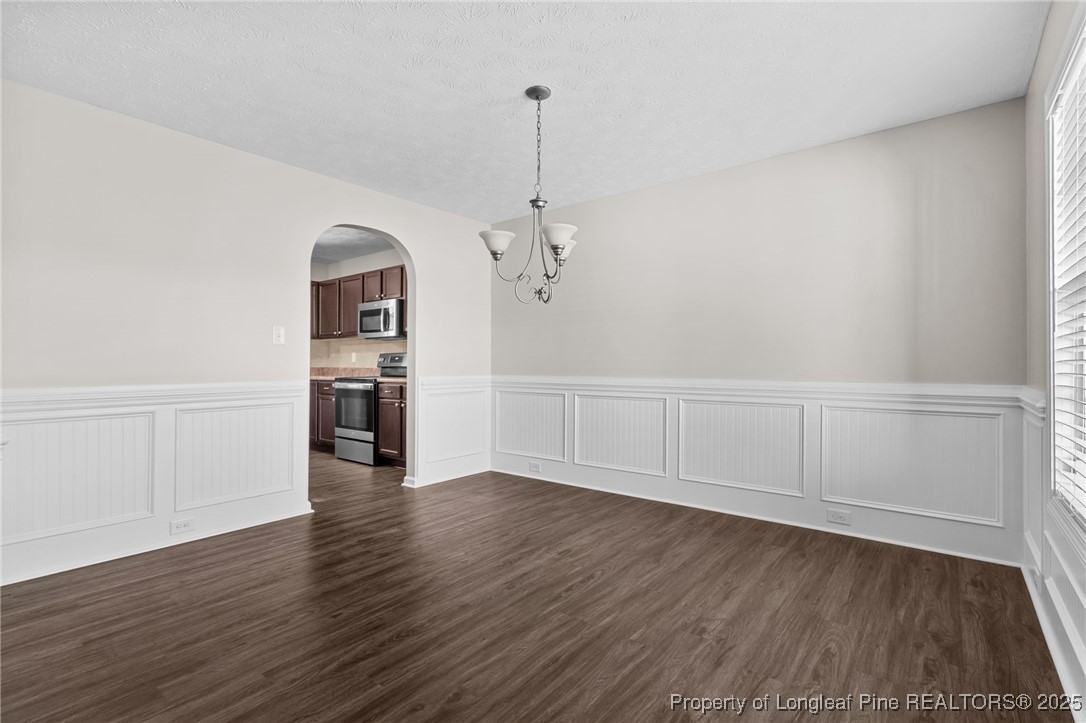 186 Scanner Court Raeford, NC 28376 - Photo 7 of 49 a view of empty room with wooden floor and stove