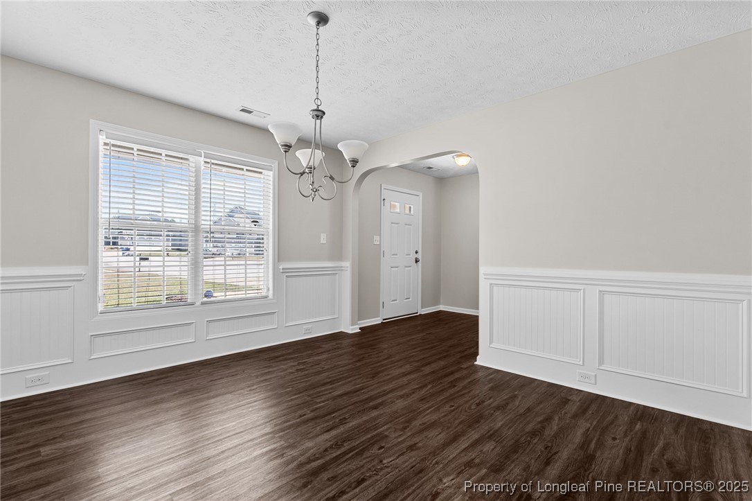 186 Scanner Court Raeford, NC 28376 - Photo 8 of 49 a view of an empty room with wooden floor and a window