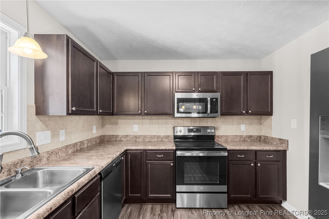 186 Scanner Court Raeford, NC 28376 - Photo 10 of 49 a kitchen with sink a microwave a stove and cabinets