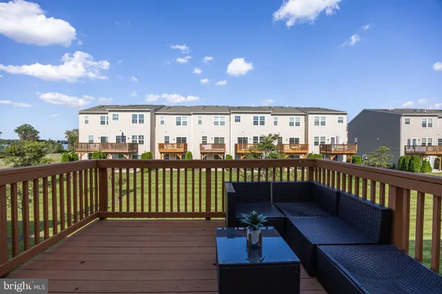a view of a balcony with wooden benches
