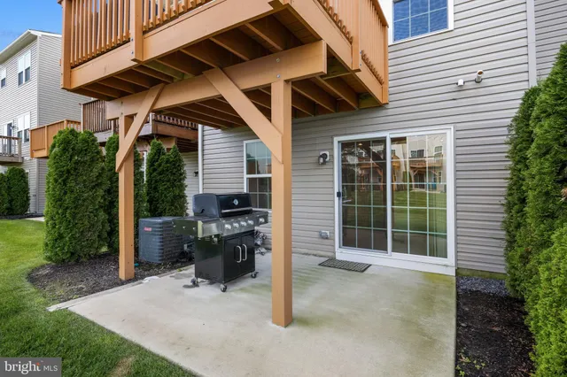 a view of a porch with a table and chairs and potted plants