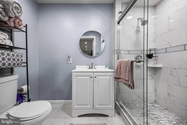 a bathroom with a toilet a sink and mirror