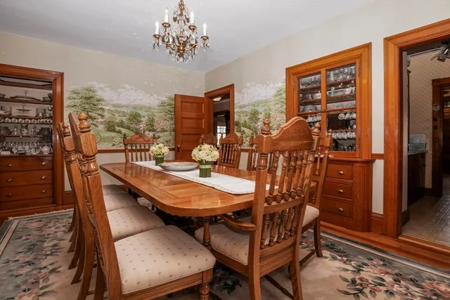 a dining room with furniture and wooden floor