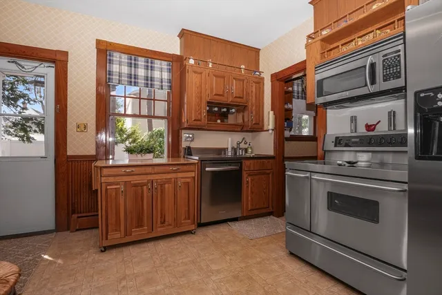 a kitchen with stainless steel appliances granite countertop a stove and a refrigerator