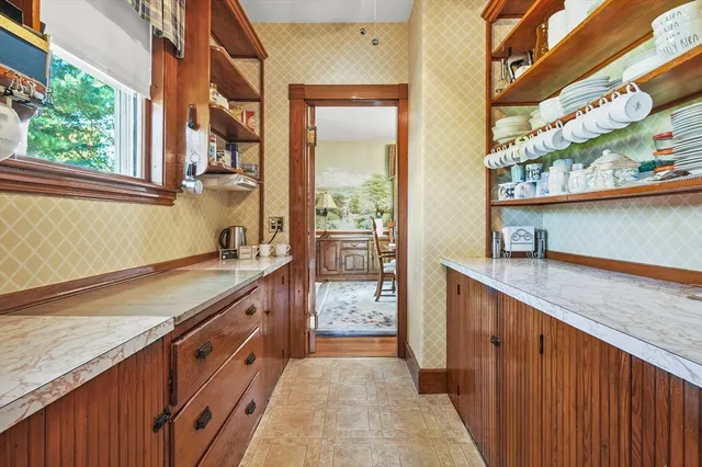 a kitchen with stainless steel appliances granite countertop a sink and a large window