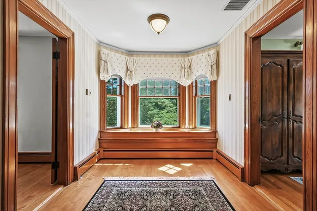 a bathroom with a window and a shower