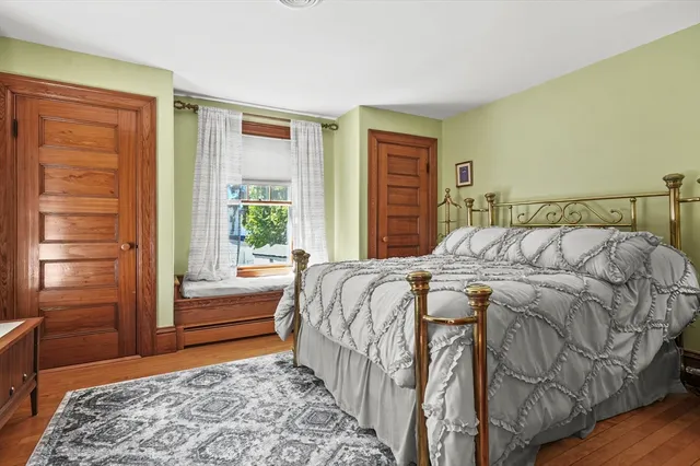 a bedroom with a bed and a window