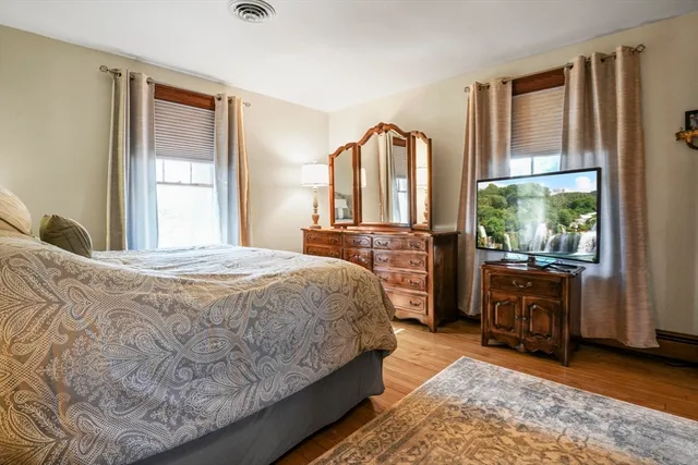 a bedroom with a bed dresser and a window