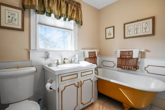 a bathroom with a sink a toilet and a mirror