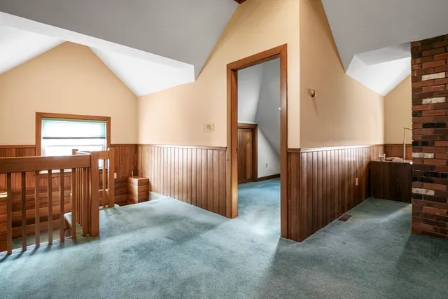 a view of a livingroom with furniture and staircase