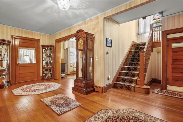 a view of an entryway with wooden floor and windows