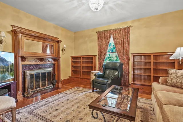 a living room with furniture a rug and a fireplace
