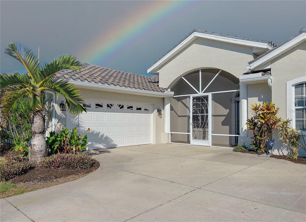 a front view of a house with a glass door and potted plants