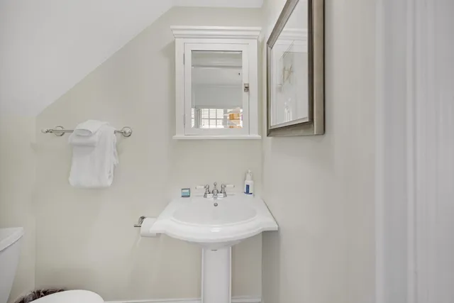 a living room with furniture a chandelier and a window
