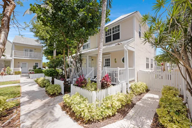 a front view of a house with a yard and fountain