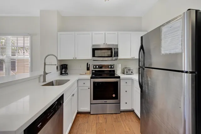 a kitchen with a refrigerator stove and sink