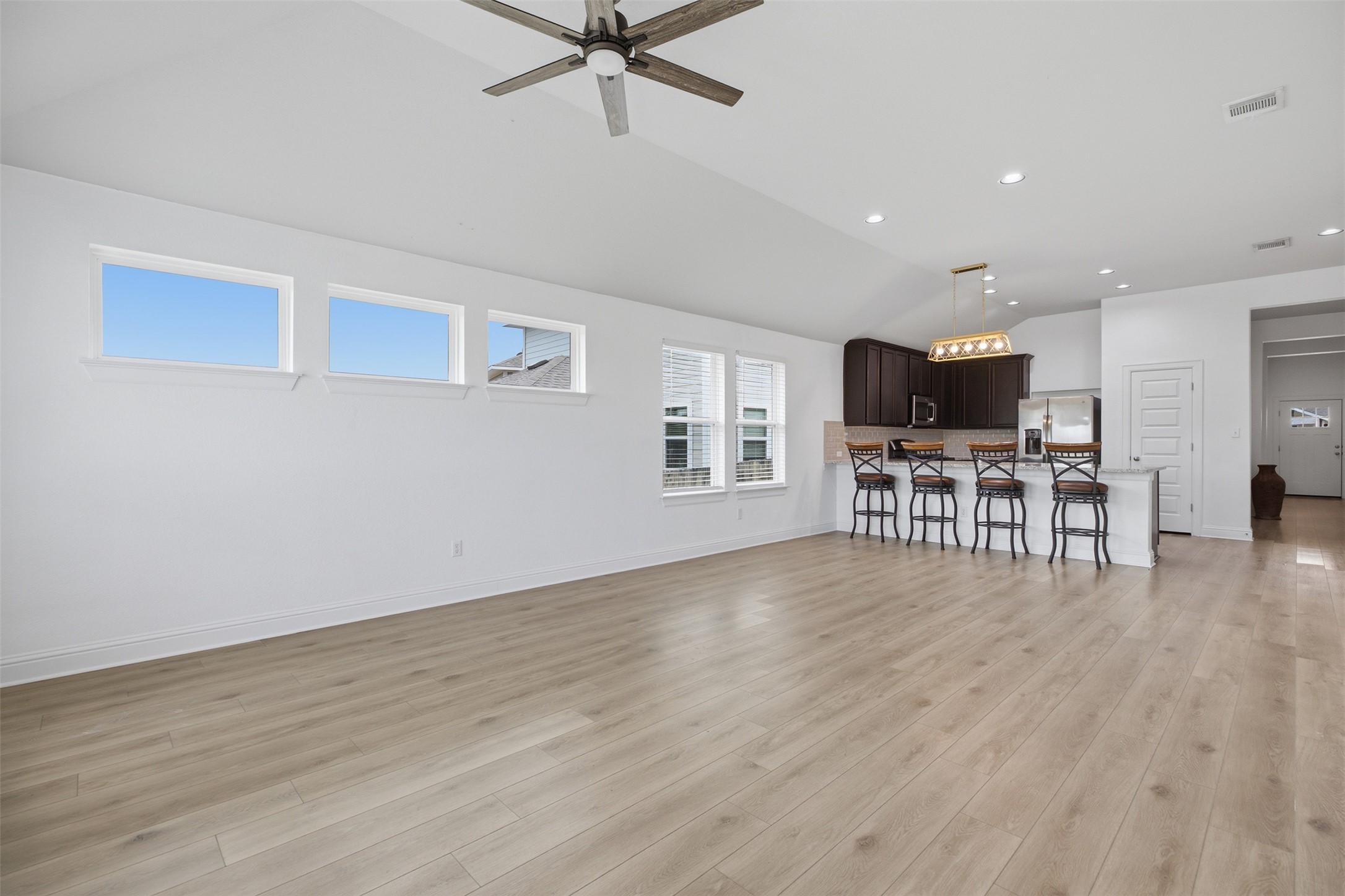 321 Gaida Loop Georgetown, TX 78628 - Photo 25 of 26 An open floorplan design seamlessly connects the main living space to the adjacent kitchen.