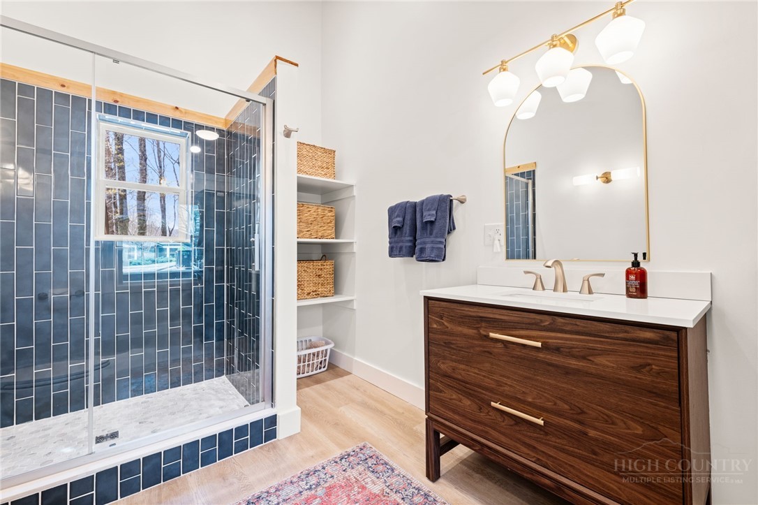 811 Pine Ridge Road Beech Mountain, NC 28604 - Photo 16 of 26 a bathroom with a sink mirror and shower