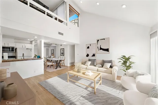 a living room with furniture kitchen view and a table