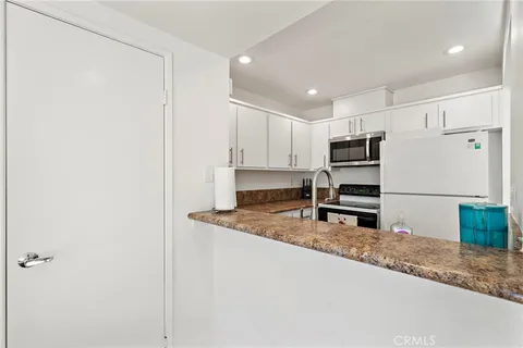 a kitchen with kitchen island a counter top space and cabinets