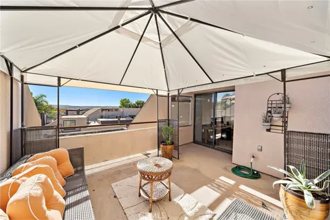 a living room with a sink a table and chairs