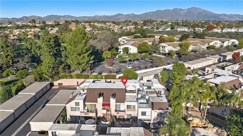 an aerial view of residential houses with outdoor space