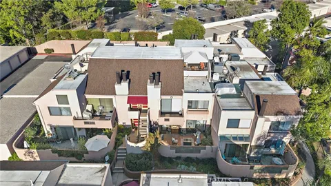 an aerial view of multiple houses with yard