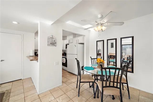 a view of a dining room with furniture and chandelier fan