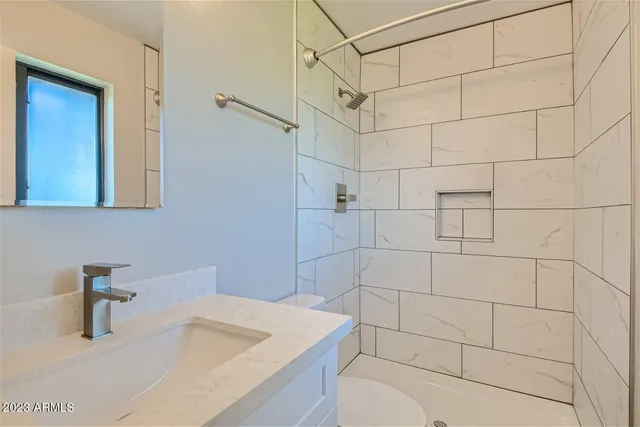 a bathroom with a sink toilet and shower