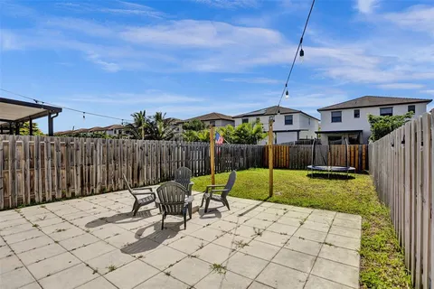 a backyard of a house with table and chairs