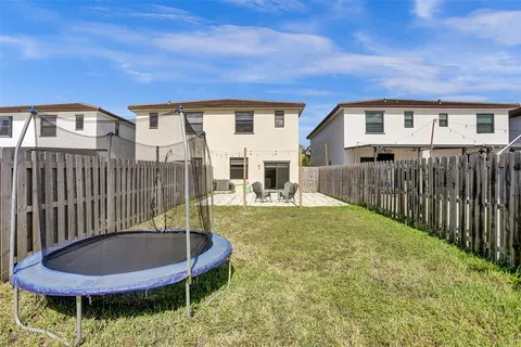 a view of a patio with a table and chairs
