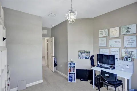 a bedroom with a bed and a night stand