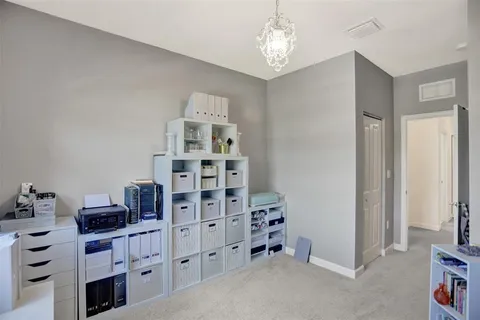 a bedroom with a bed and mirror